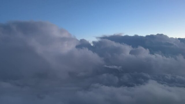 A dramatic turbulent winter sky at sunset through the pilot&rsquo;s eyes. Aerial footage taken from a jet cockpit flying at suset. 4K 60FPS