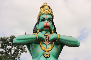 The Hindu monkey god Hanuman tears apart his chest.