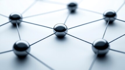 Abstract network concept image featuring interconnected metallic spheres on a light background. The spheres are dark grey and reflective, connected