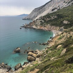 Fototapeta premium view of the coast of line with moody clouds and blue water 