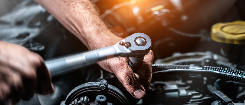 Auto mechanic working in garage. Repair service. Motion blur shot - Powered by Adobe
