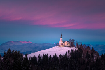 A church on top of the hill in the winter sunset