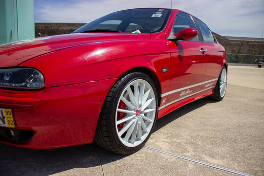 Red alfa romeo 147 gta parking outdoor on a sunny day