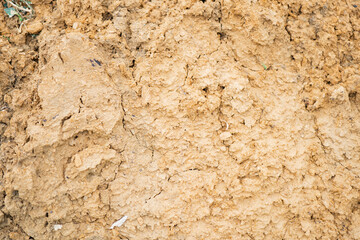 Brown earth texture revealing dry soil layers in natural setting during daylight