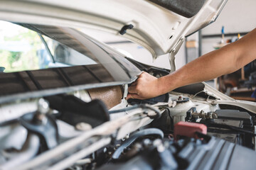 Installing a steel mesh over a car air conditioning vent to prevent pests from entering the vehicle's system.