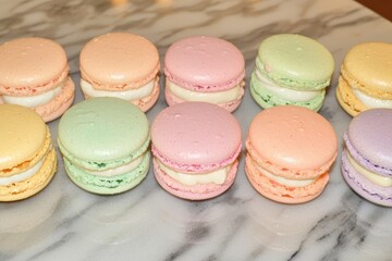 Macarons (France) A colorful assortment of French macarons neatly arranged on a marble surface.Macarons (France) A colorful assortment of French macarons neatly arranged on a marble surface.