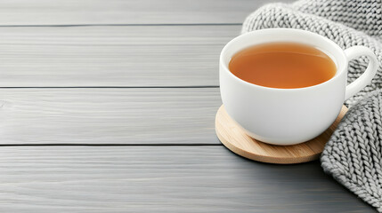 Warm tea, cozy knit, wood table, winter comfort, relaxing beverage