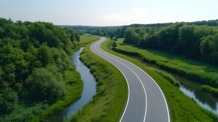Winding road through lush green countryside, river alongside, aerial view, perfect for travel brochures