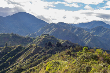 Naklejka premium Tierradentro, Inza, Cauca, Colombia. Beautiful landscape of the Andes Mountains. Valley, lush vegetation, peak, crops. Picture taken from the Alto del Aguacate.