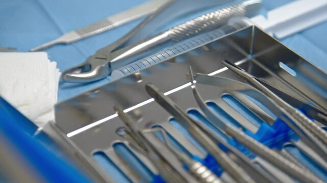 Sterile tools prepared for tooth extraction and dental implant in the dental office. Dental implant burs and drills arranged on the dentist's table.