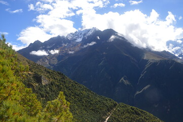 Hiking in the stunning Khumbu Valley surrounded by glaciars and snowy peaks in the Himalayan...
