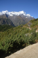 Hiking in the stunning Khumbu Valley surrounded by glaciars and snowy peaks in the Himalayan Everest Base Camp Trek