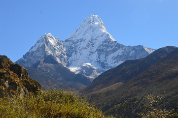 Hiking in the stunning Khumbu Valley surrounded by glaciars and snowy peaks in the Himalayan Everest Base Camp Trek
