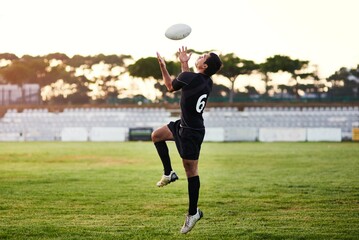 Man, play and rugby with ball for outdoor, game or challenge in exercise, wellness or fitness. Male person, athlete and recreation facility on pitch for match, sports and training in stadium or arena