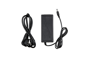 A black power adapter with two cables, one with a plug and the other with a connector, isolated on a white background, used for electronic devices.