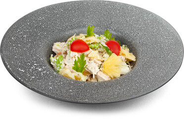 Salad with tomatoes and pineapple on a plate on a white background