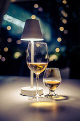 Glasses of white wine and cognac are on the table in the restaurant
