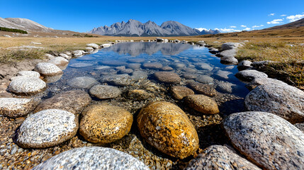 Mountain reflection in clear pool, autumn grassland