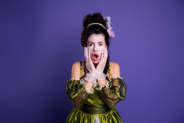 Young woman dressed in baroque costume with a surprised expression, posing against a vibrant purple background