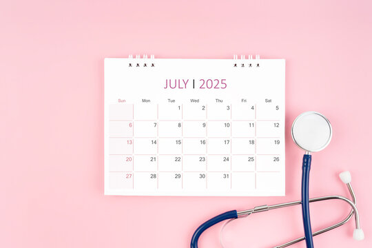 July 2025 desk calendar and stethoscope, Medical appointment concept.