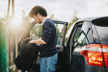 A parent helps their son get ready for school by the car, capturing a touching morning moment. The...