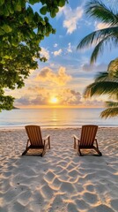 Two comfortable loungers sit on a sandy beach, shaded under a large umbrella as the sun sets over the tranquil ocean, creating a peaceful vacation atmosphere