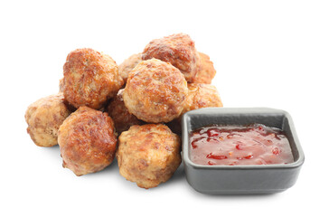 Pile of delicious meatballs and bowl with ketchup isolated on white
