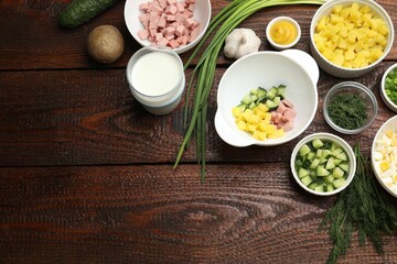 Ingredients for okroshka soup on wooden table, flat lay. Space for text