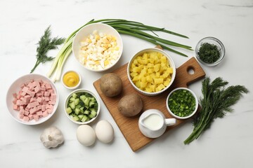 Ingredients for okroshka soup on white marble table, flat lay