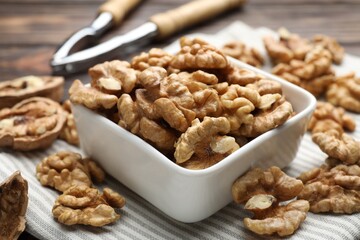 Peeled walnuts in bowl on table, closeup