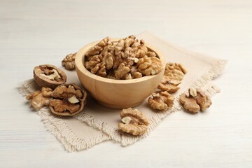 Peeled walnuts in bowl on light table