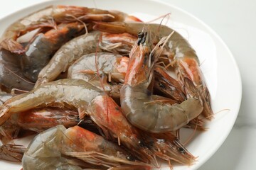 Fresh raw shrimps on white table, closeup. Sea food