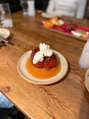 Traditional Turkish style quince dessert. The quince is cooked until soft, sherbet is poured on it, and served with cream and walnuts