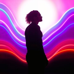Silhouette of woman against neon light waves
