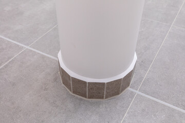 The Stylish Column Base Design features meticulously crafted Elegant Tile Work that captivates