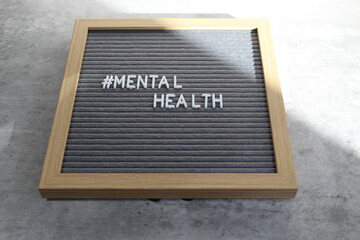 Mental health written out on a letter board in white letters. 