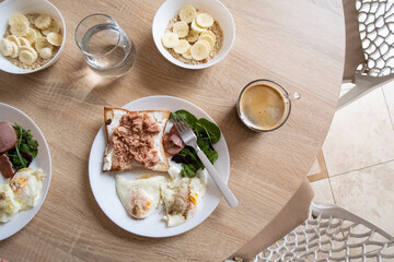 healthy breakfast, eggs and toast with tuna and coffee
