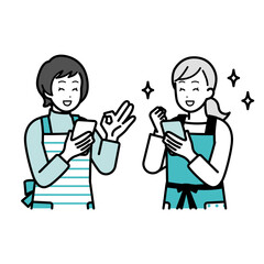 Women having a conversation while holding a cell phone.
