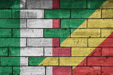 colourful painted big flag of italy and flag of republic of the congo on a massive old brick wall background. concept