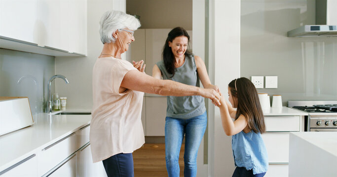 Mother, daughter and grandmother with dancing in home for celebration, bonding or connection. Energy, women or kid in circle in kitchen with moving together for weekend entertainment, love or support