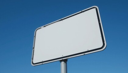 Obraz premium Blank White Rectangular Signboard Against Clear Blue Sky Outdoor Advertising Space