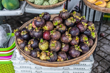 Exotic and seasonal tropical fruits mangosteen at market in Asia