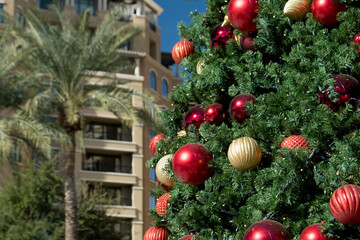 Decorated Christmas tree and palms during holiday season at Scottsdale Waterfront near South bridge