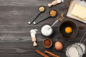 Baking powder and other products on grey wooden table, flat lay. Space for text