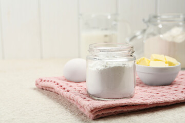 Baking powder and other ingredients for making dough on table, space for text
