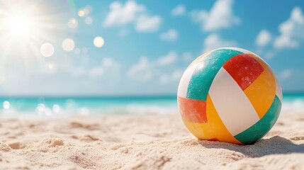 Obraz premium A vibrant beach volleyball rests on a sunlit sandy shore, epitomizing summer fun, sports, and the joy of beach life amidst a serene ocean backdrop and bright sunshine.