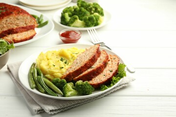 Delicious baked turkey meatloaf with mashed potato served on white wooden table, closeup. Space for text