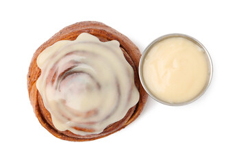 Tasty cinnamon roll with cream isolated on white, top view