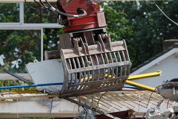Construction crew dismantles primary school building showcasing remnants of student memories