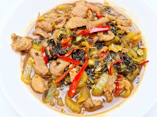 Delicious stir-fry of pickled Chinese cabbage, pork, and red peppers, coated in a savory cornstarch sauce.